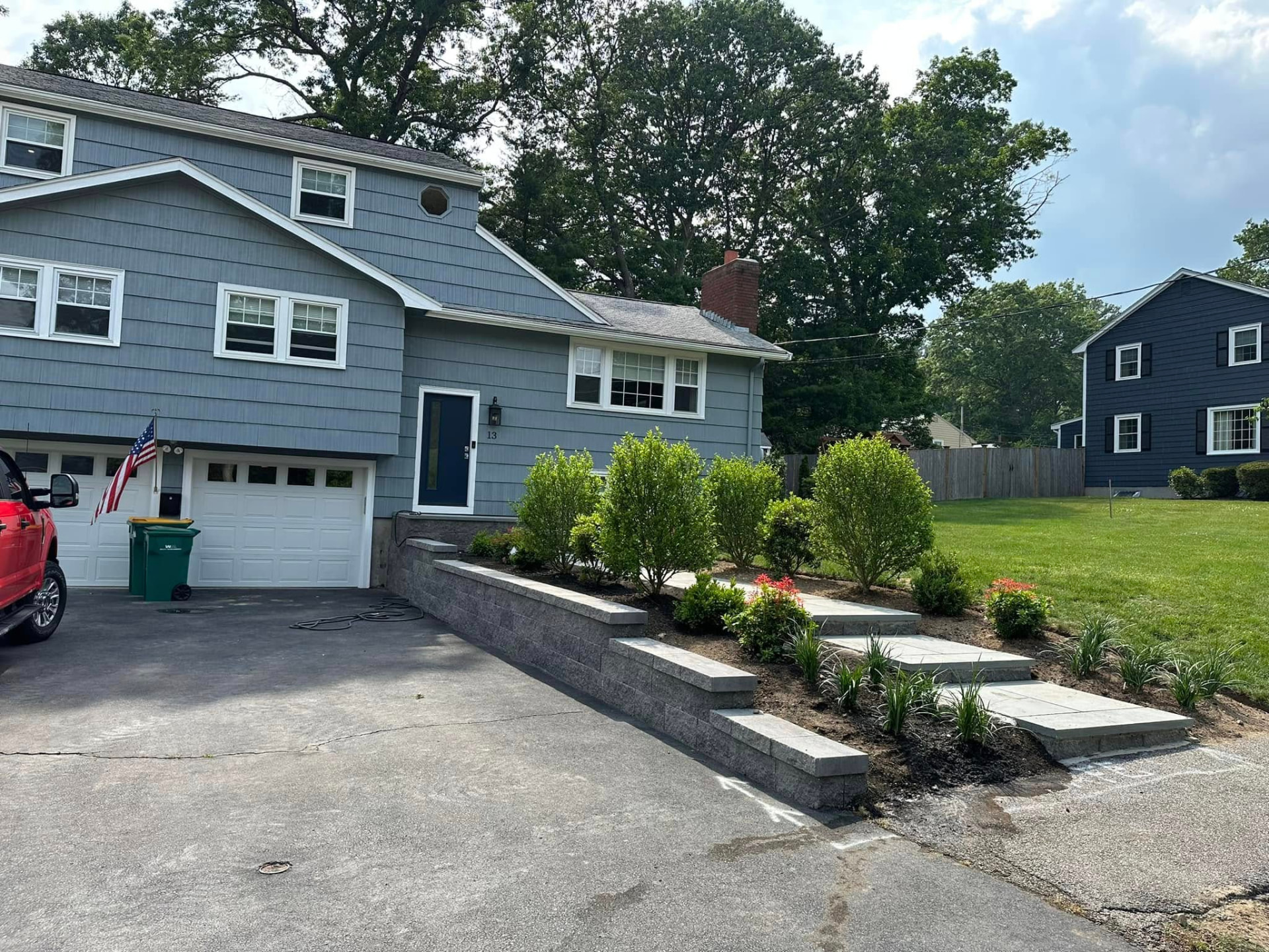 New plantings and bluestone steps beside a freshly built retaining wall